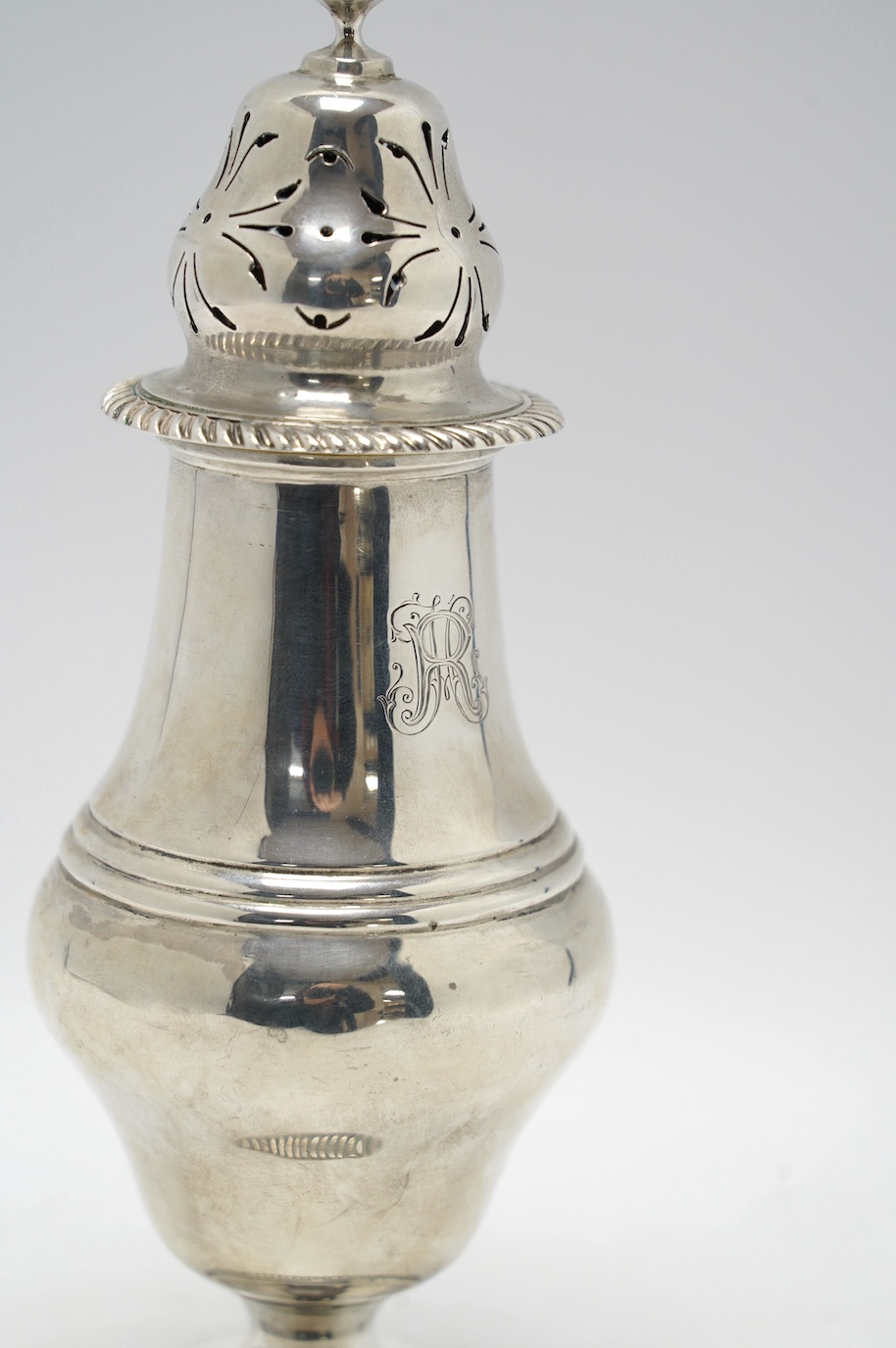 A George V silver inverted pear shaped pedestal sugar caster, Charles Stuart Harris & Sons, London, 1911, 21.6cm, 6.5oz. Condition - fair